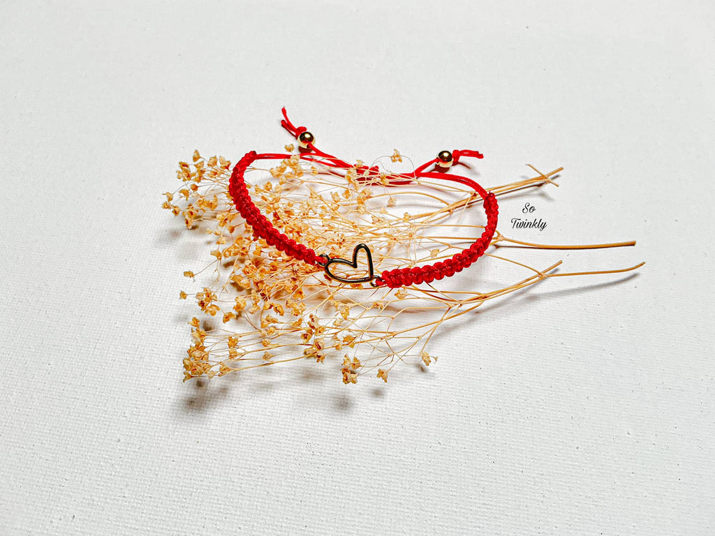 Handmade bracelet with gold heart-shaped metallic charm on a soft adjustable nylon cord