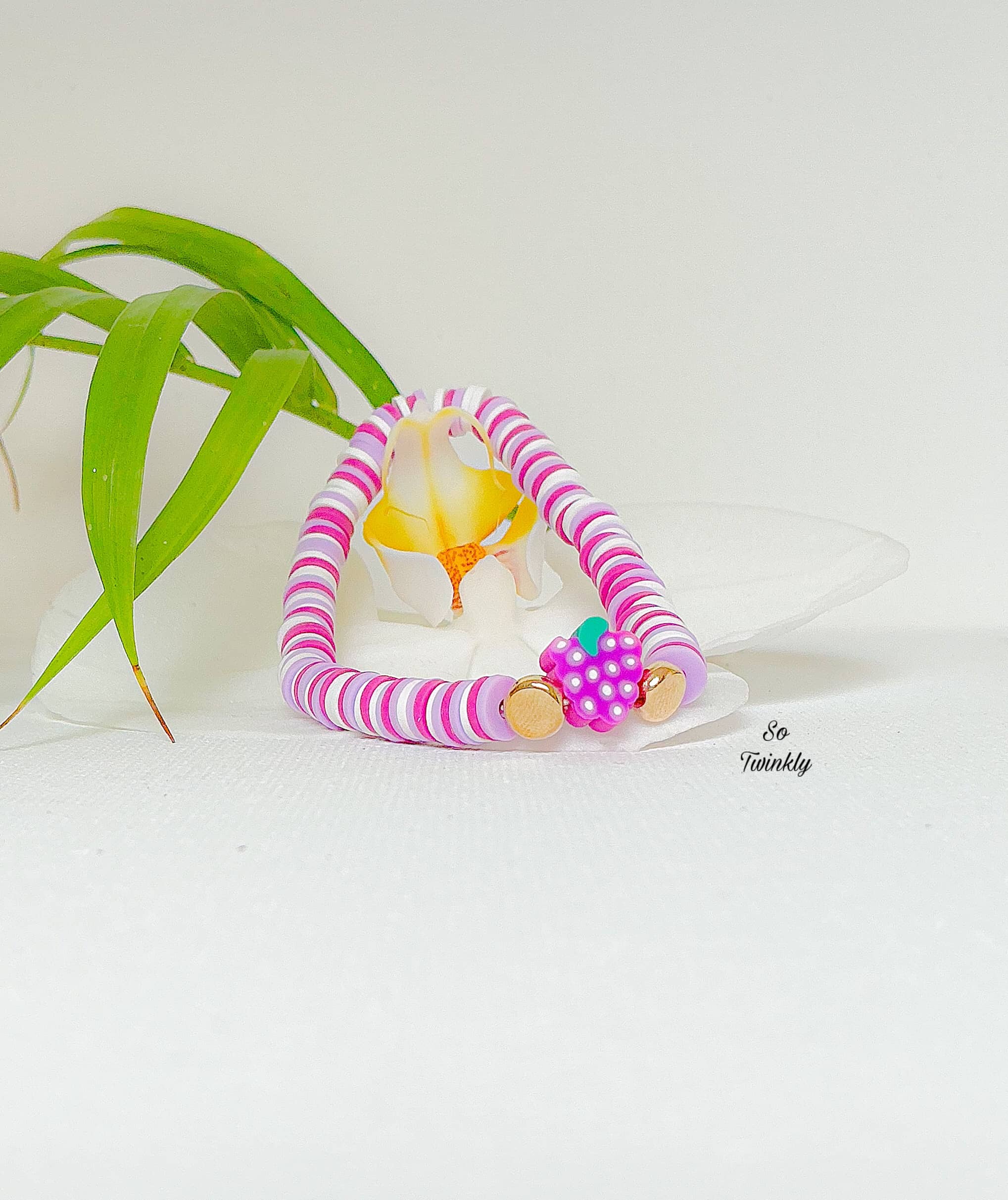 Handmade grape bracelet with violet and purple polymer clay beads and a grape fruit charm