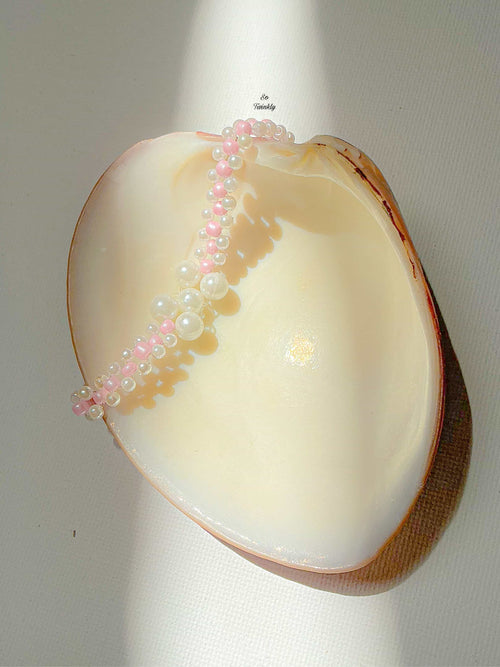 Handmade bracelet with soft pink and white acrylic pearls in a minimalist, elegant design