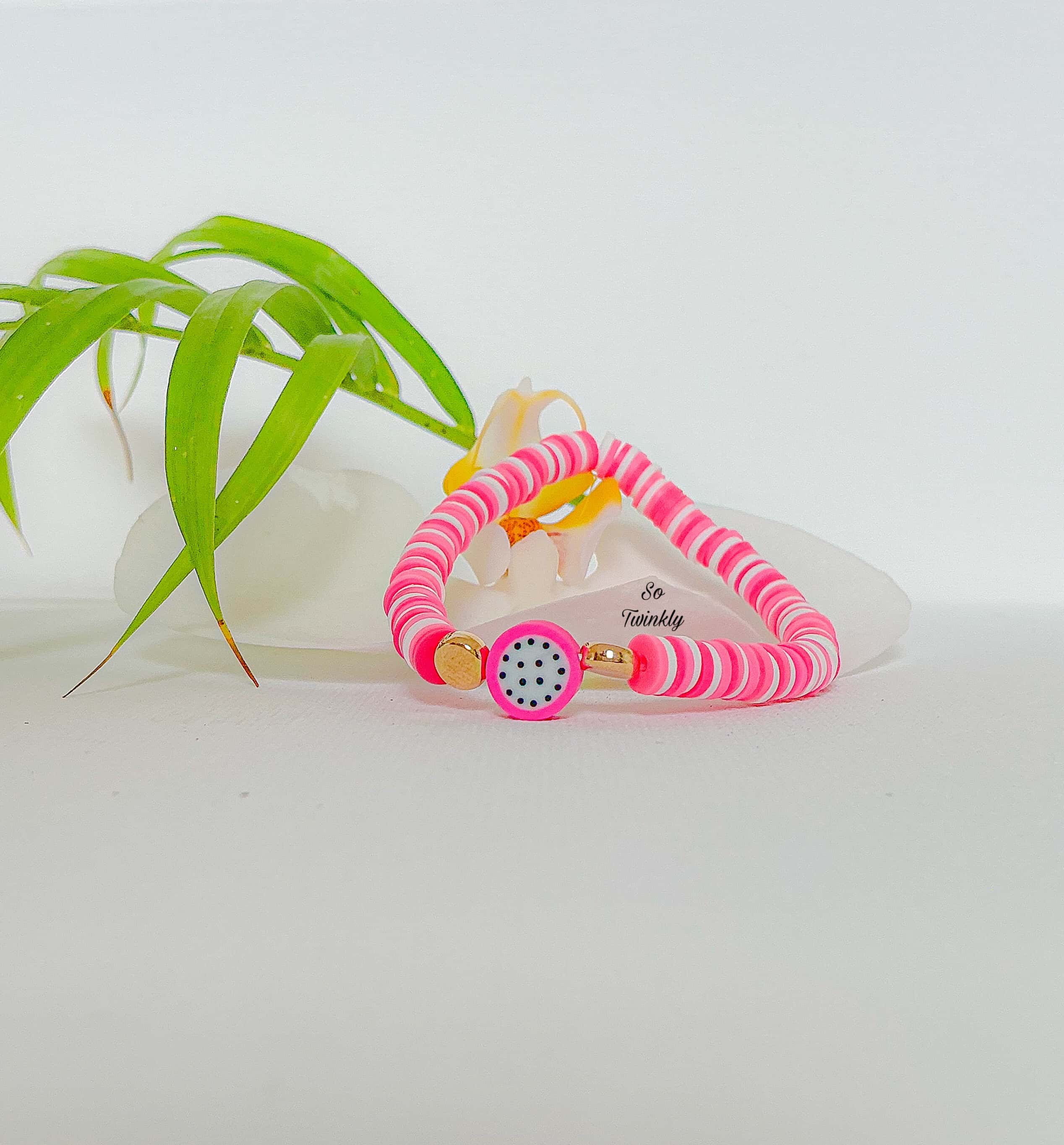 Handmade melon bracelet with neon pink and blush polymer clay beads and a melon charm
